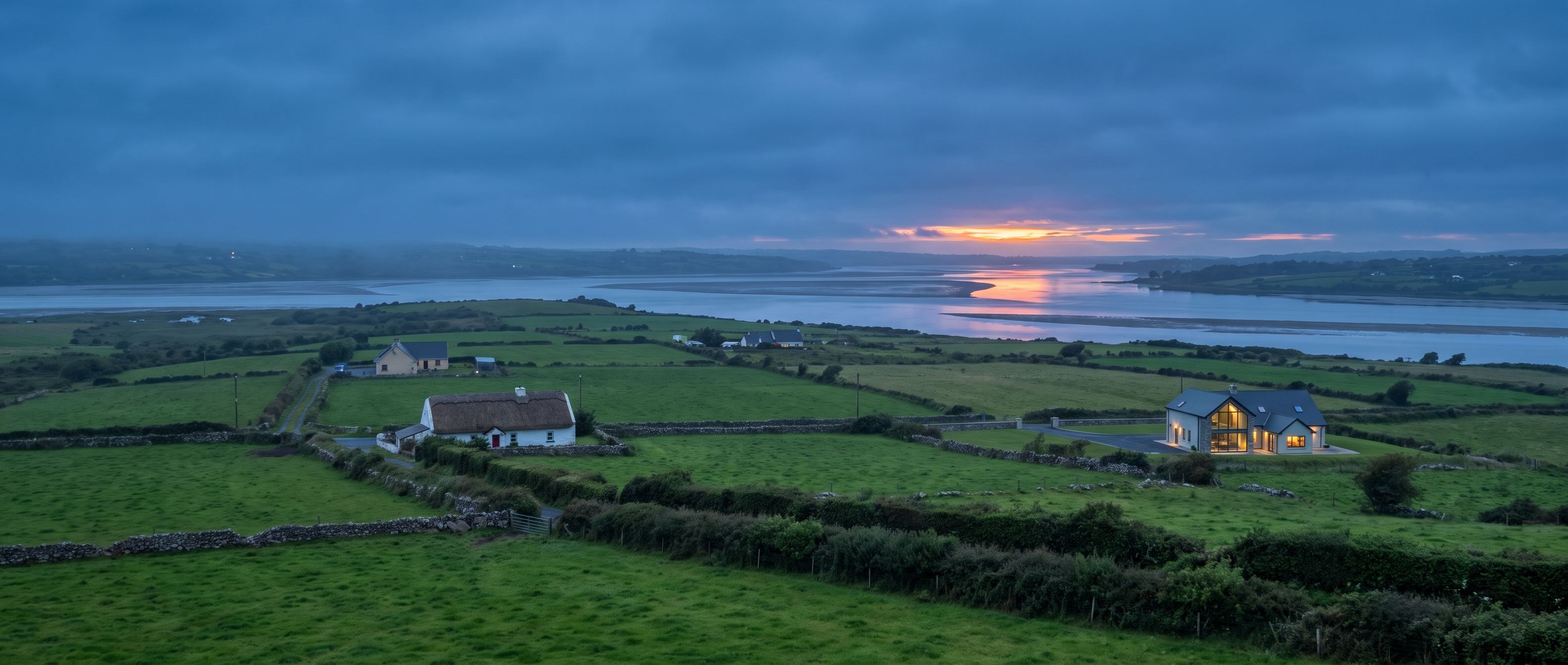 Green countryside and homes along the Shannon estuary near Ballynacally, Co. Clare